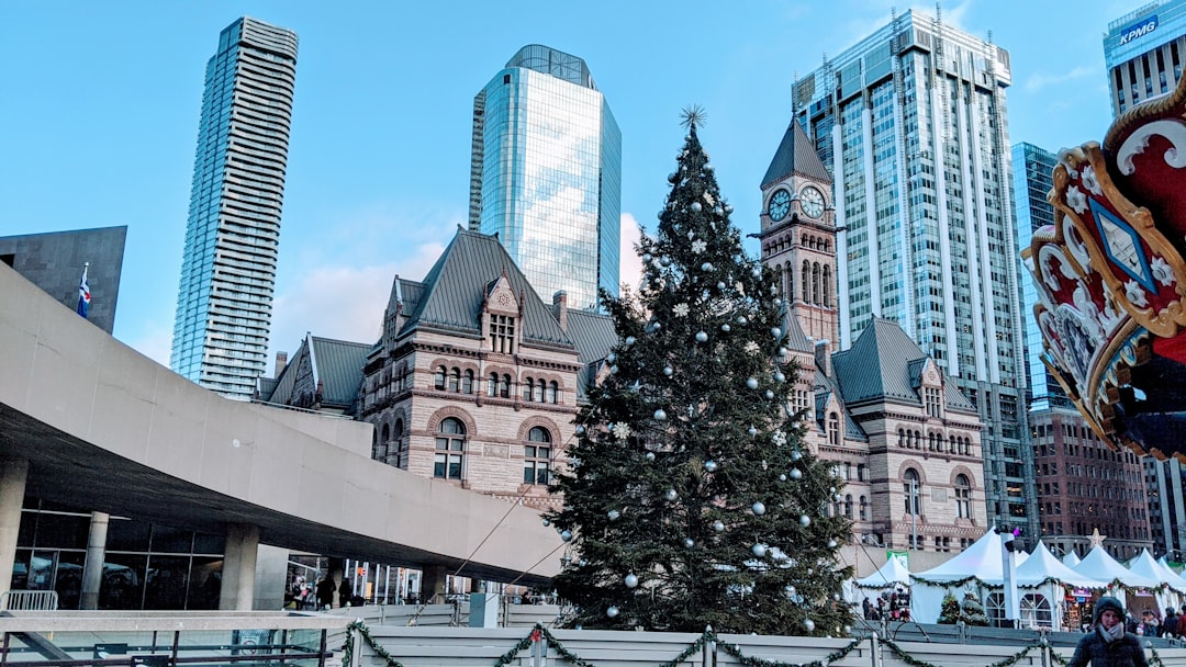 a large christmas tree in front of a large building,