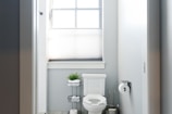 Compact toilet perfectly fitted in a small, efficient bathroom space.
