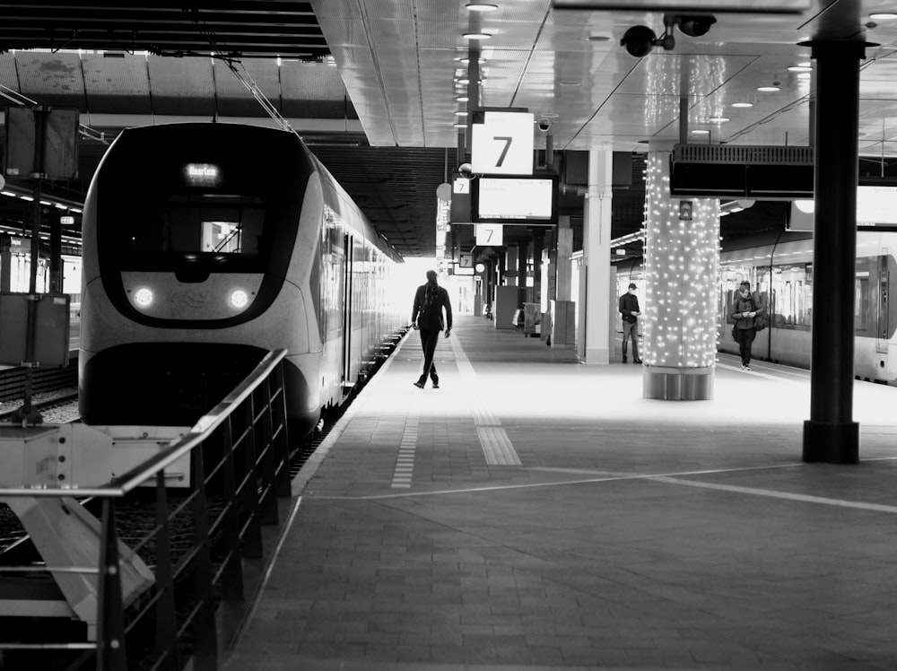 a black and white photo of a train at a train station