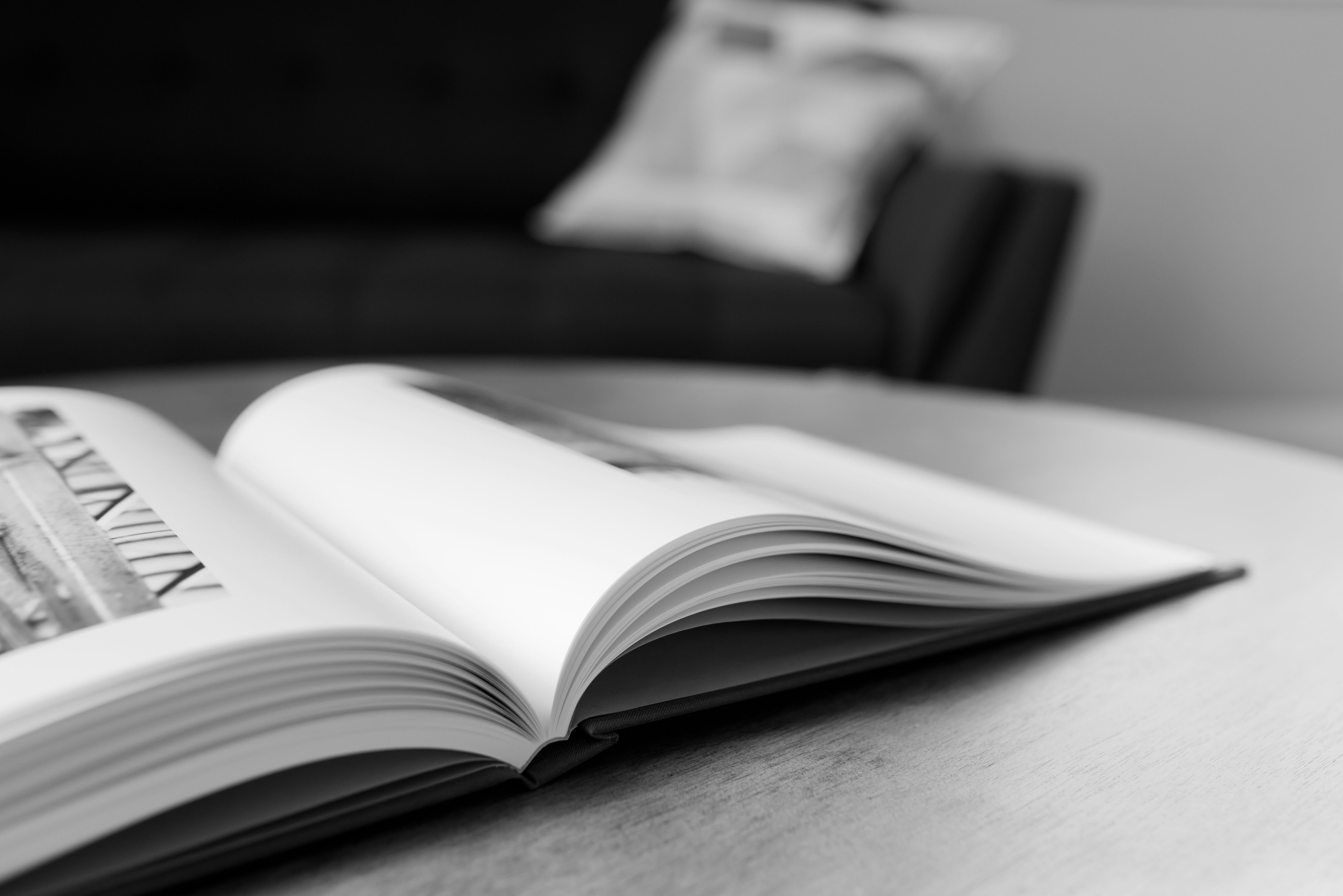 an open book sitting on top of a wooden table