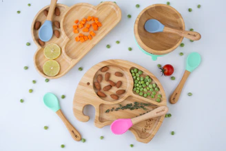 a variety of wooden spoons and bowls filled with food