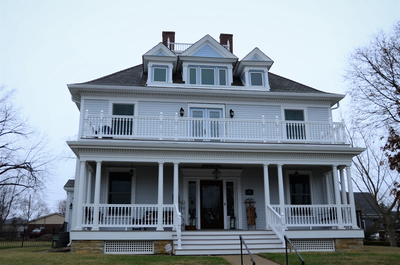The white house on North Bridge Street behind its porch