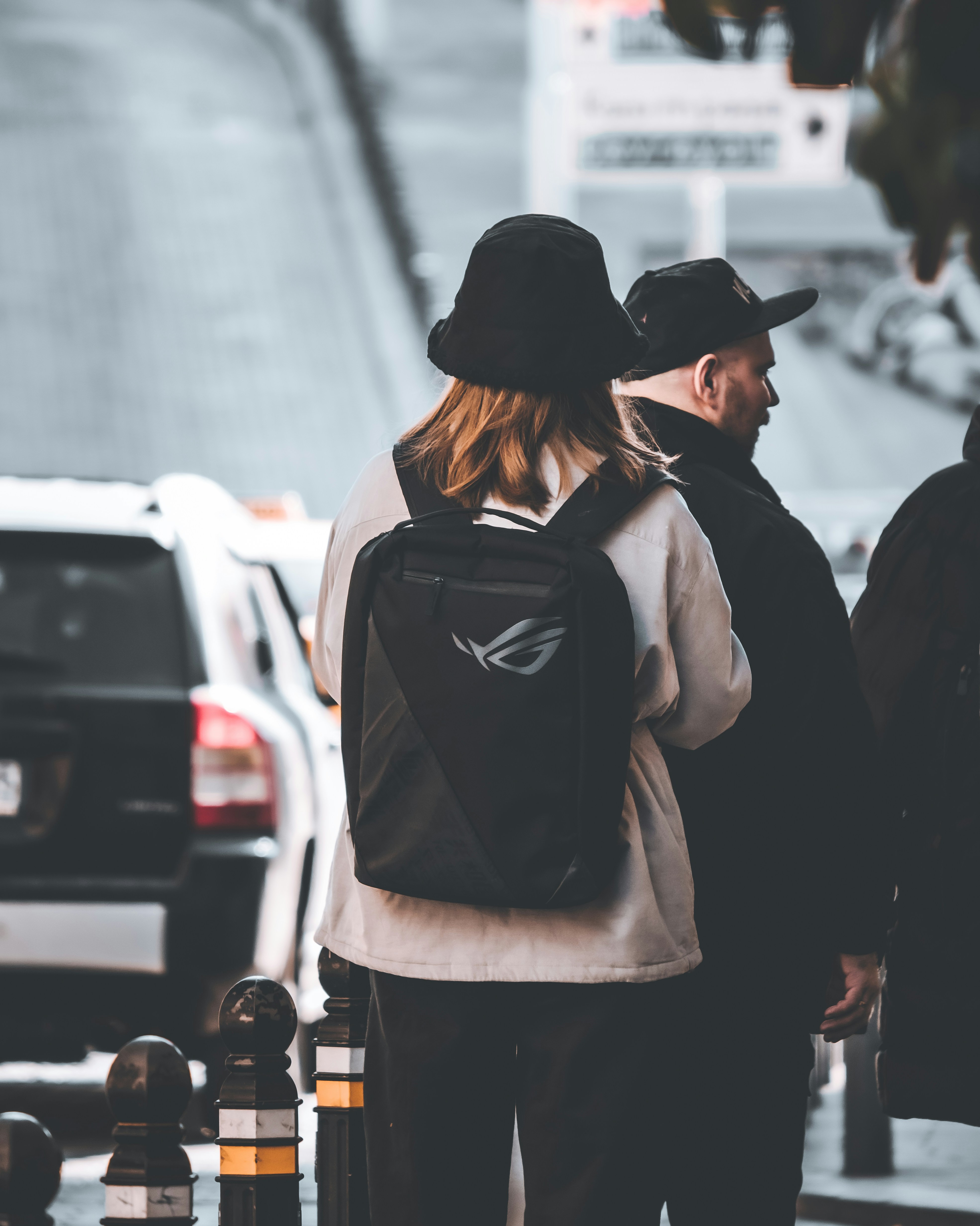 a couple of people walking down a street