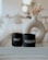 two black cups sitting on top of a white tray