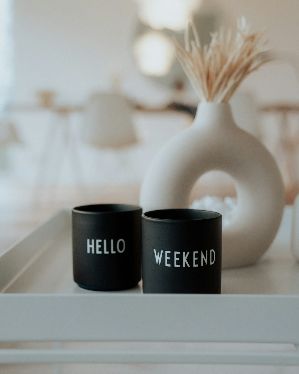 two black cups sitting on top of a white tray