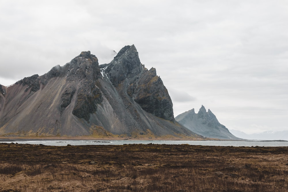 a mountain range with a body of water in the foreground