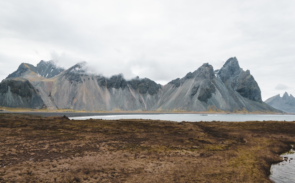 a mountain range with a body of water in the foreground