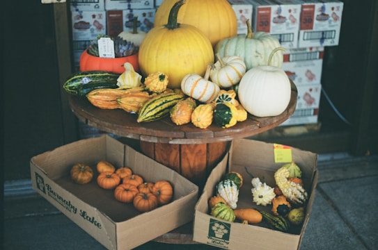 a three tiered display of pumpkins and gourds
