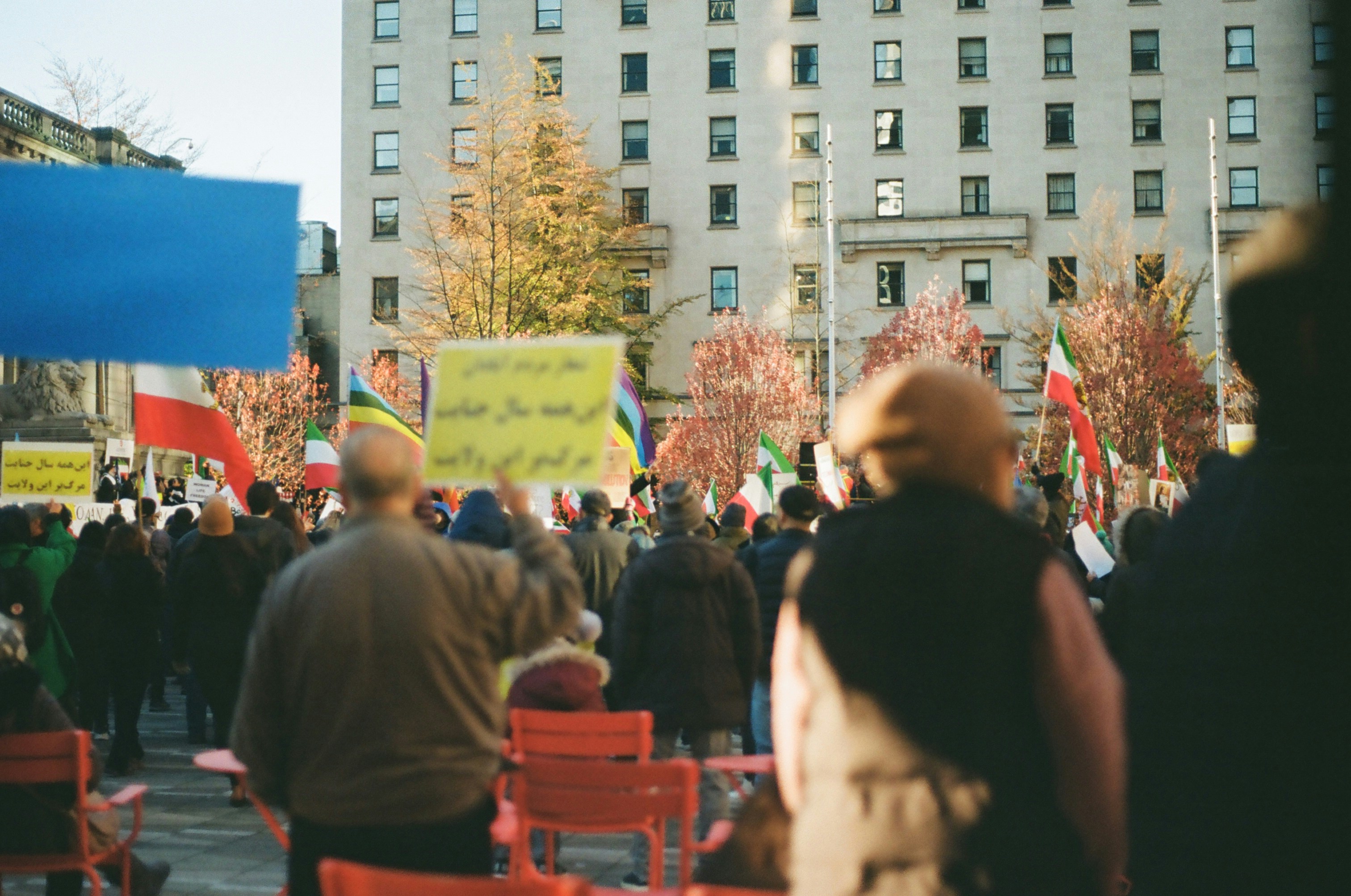 a group of people standing around holding signs
