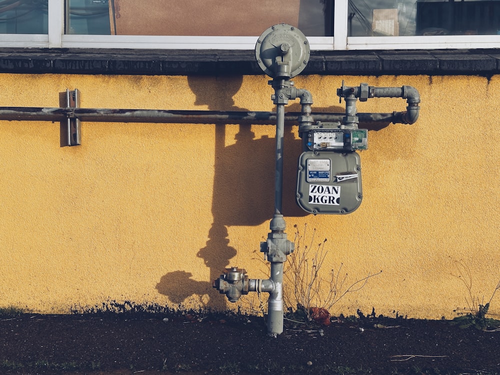 a fire hydrant next to a yellow building