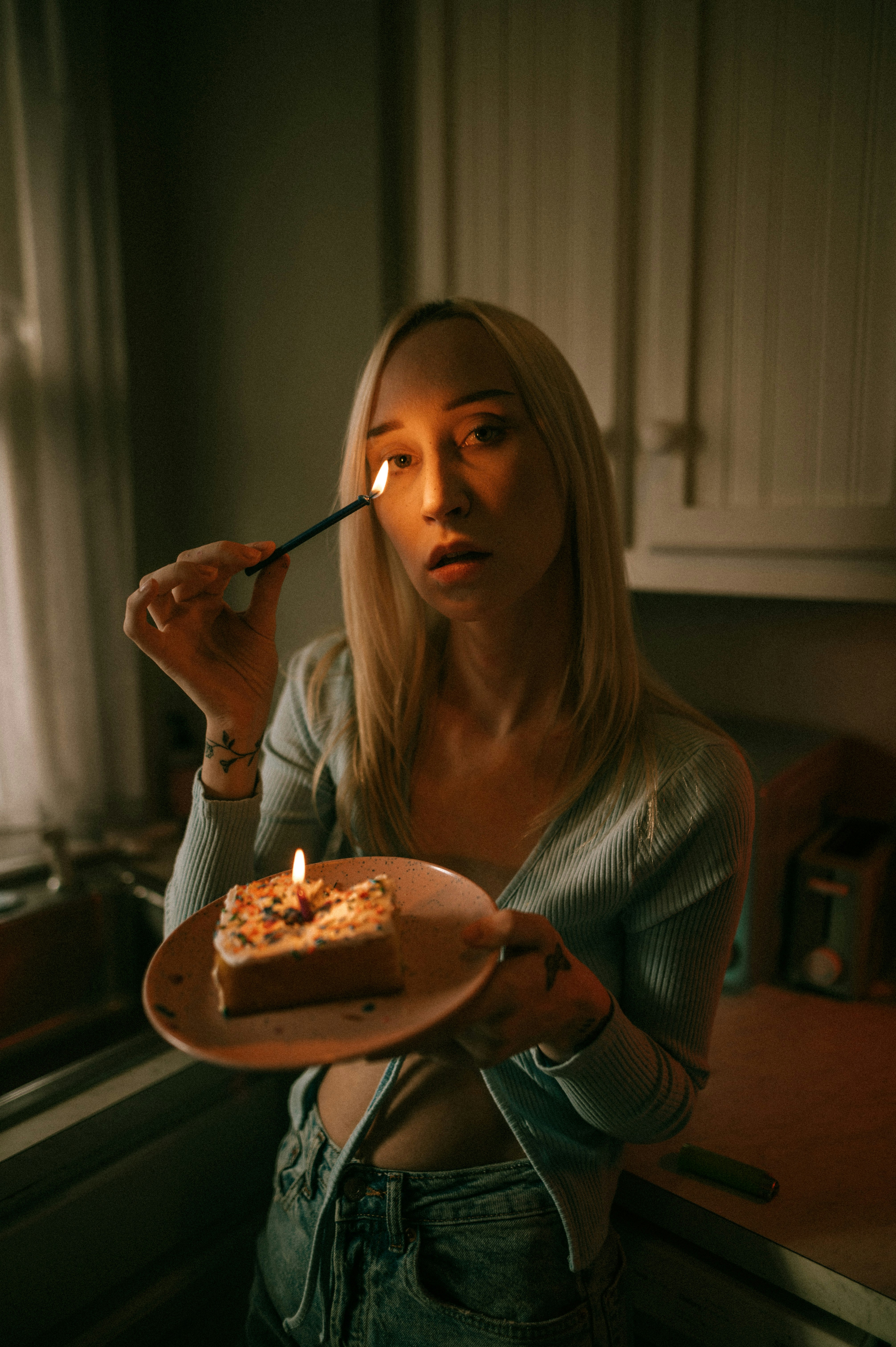 a woman holding a plate with a piece of cake on it
