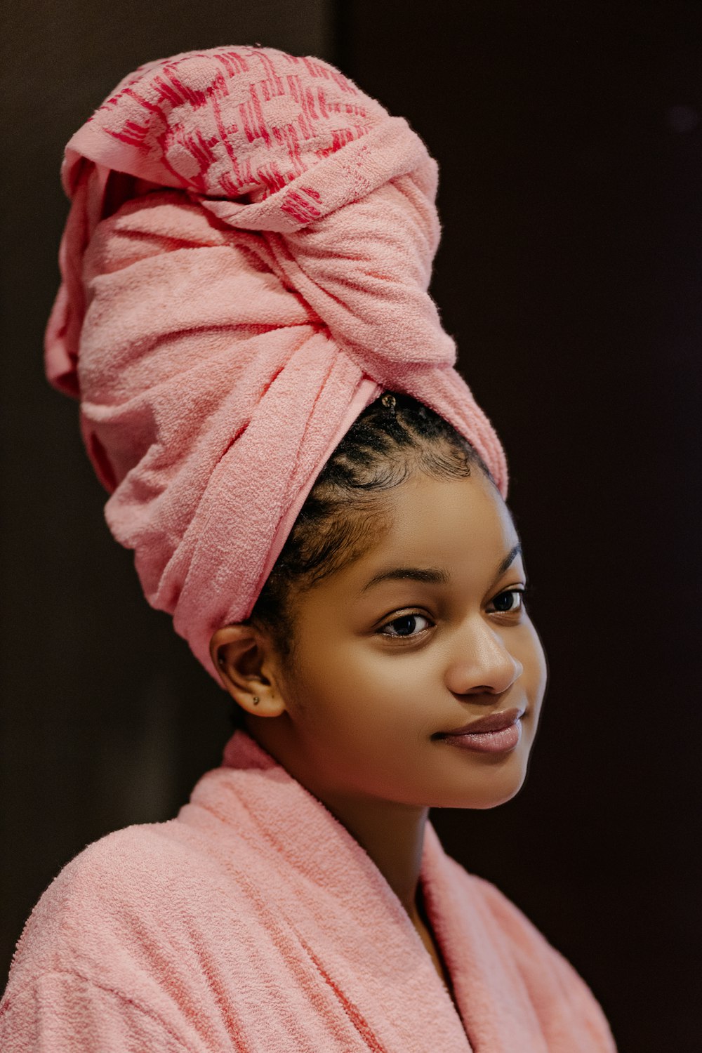a woman wearing a pink towel wrapped around her head