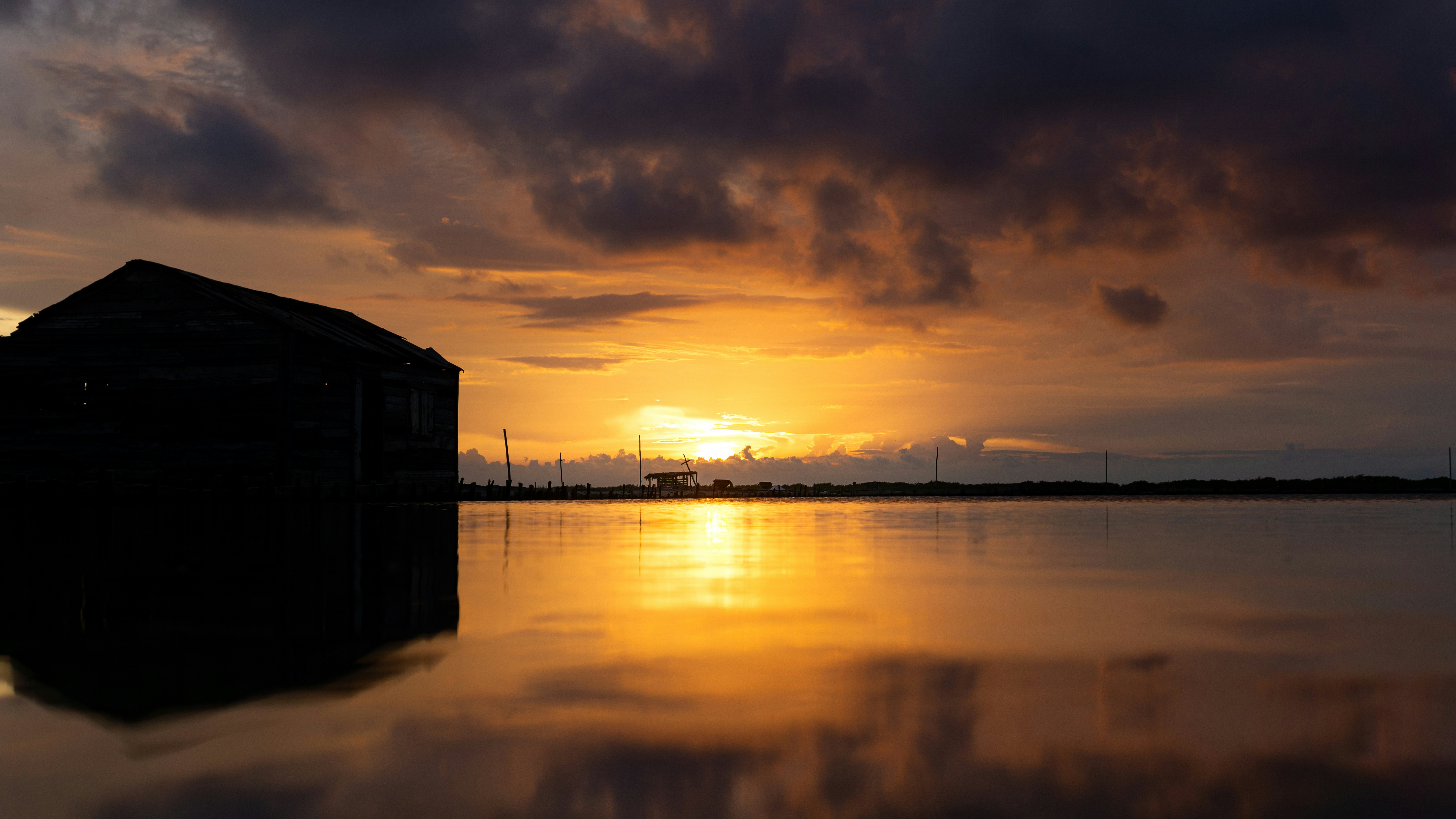 the sun is setting over a body of water