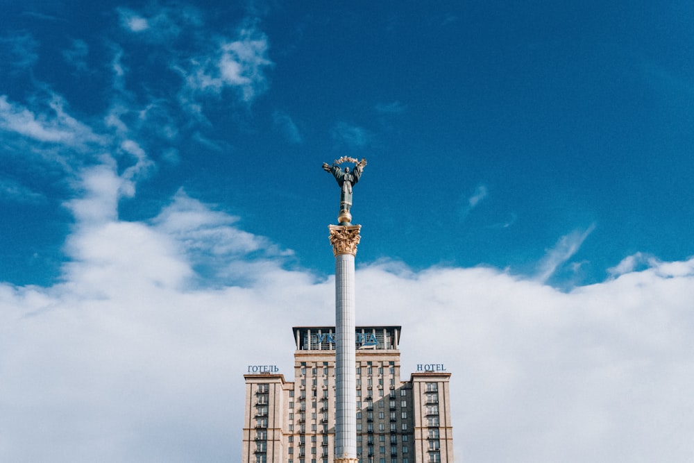 a tall building with a statue on top of it