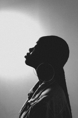 a black and white photo of a person with earphones