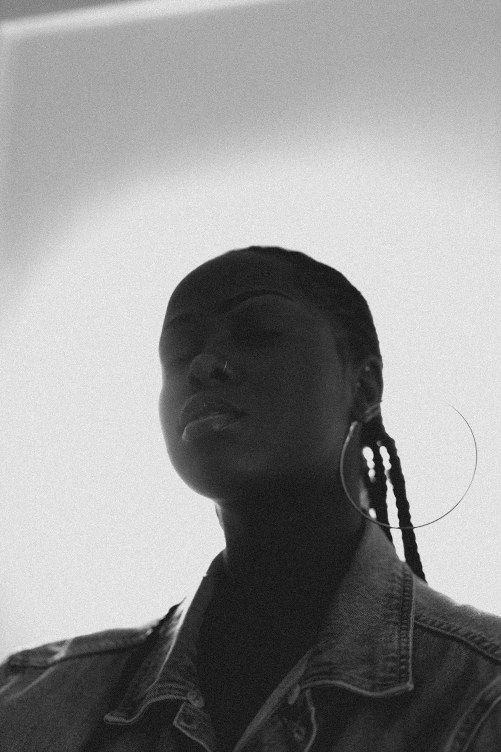 a black and white photo of a woman with braids