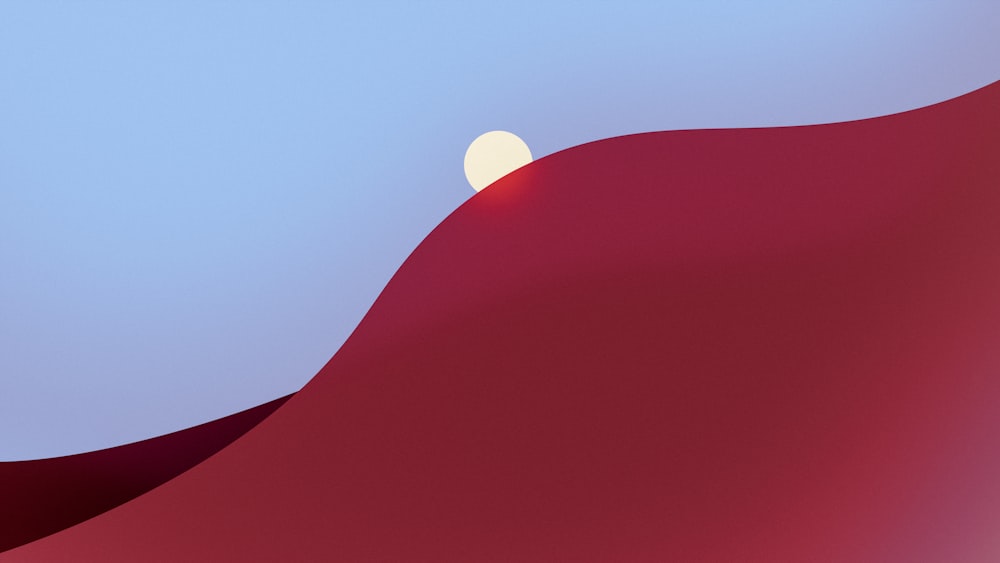 a red hill with a half moon in the sky