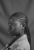 Black woman with cornrows and a denim jacket