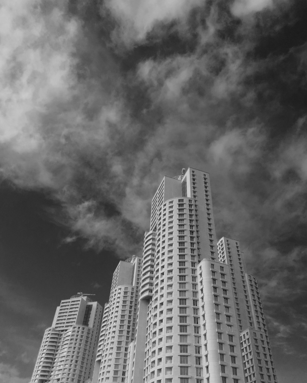 a black and white photo of tall buildings