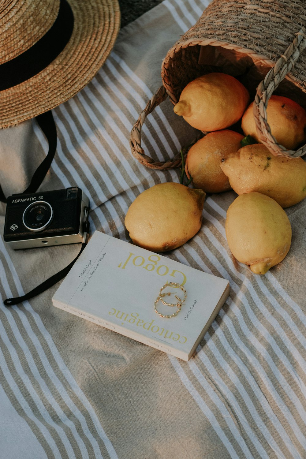 a bag of lemons and a book on a bed