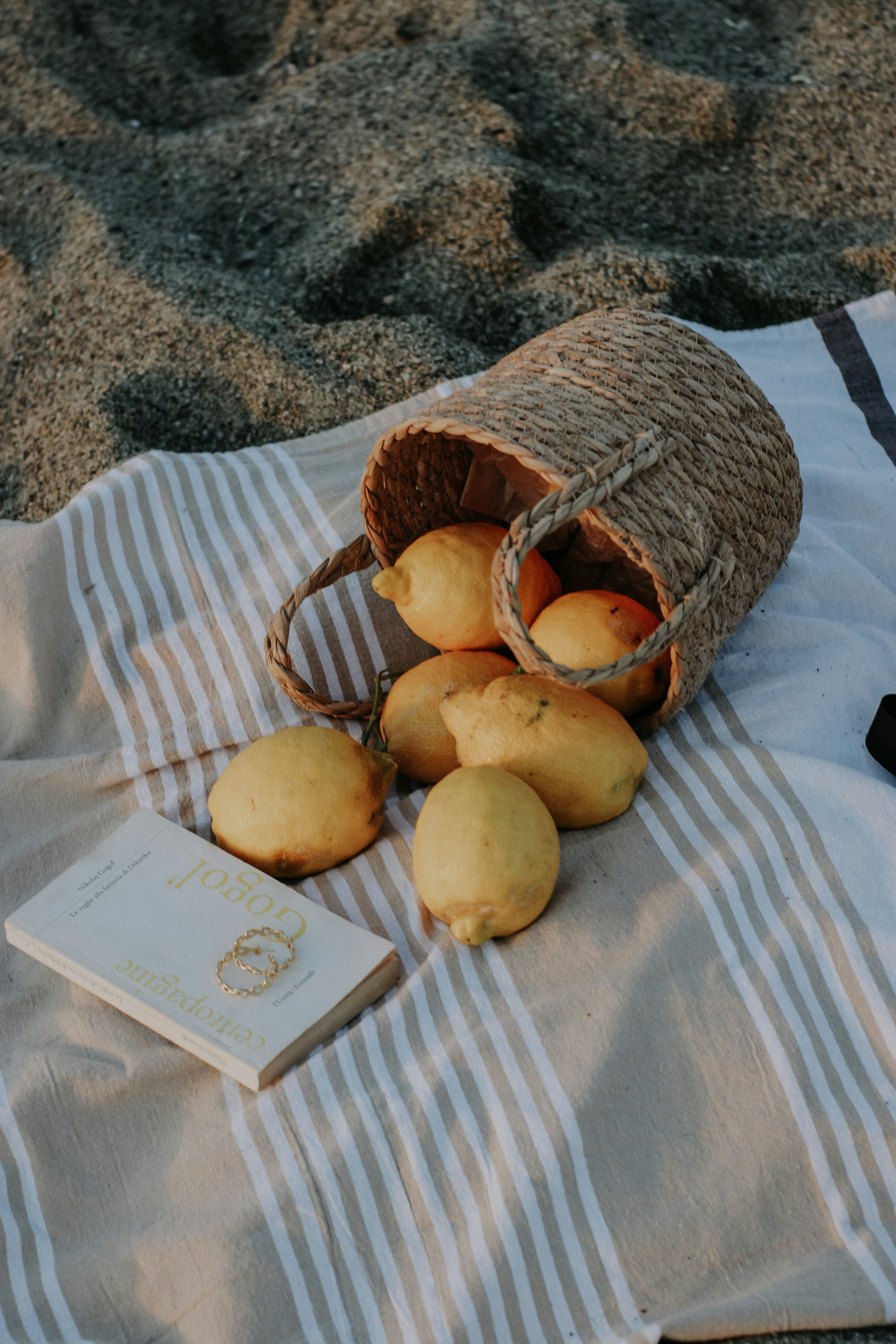 a bag of lemons and a book on a towel