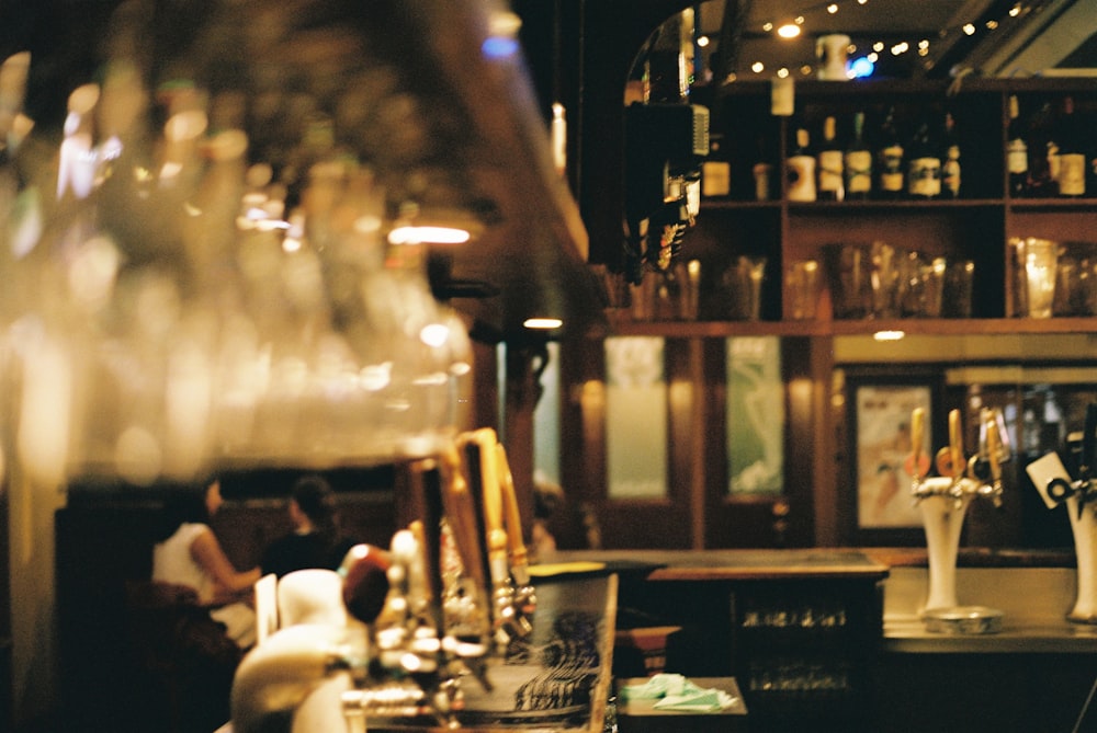 a row of wine glasses sitting on top of a bar