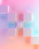 a blurry image of cubes on a pink and blue background