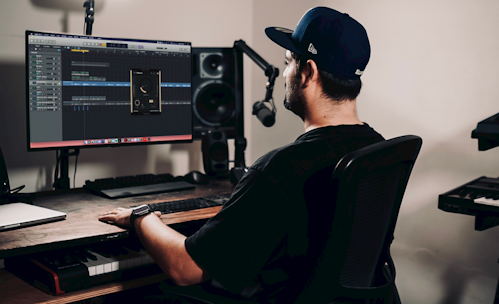 a man sitting at a desk in front of a computer