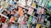 A variety of magazines are displayed in a chaotic but organized manner, featuring popular titles with colorful covers. The magazines are stacked and overlapping, showcasing diverse topics like music, science, travel, and lifestyle.