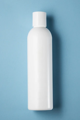 a white bottle on a blue background