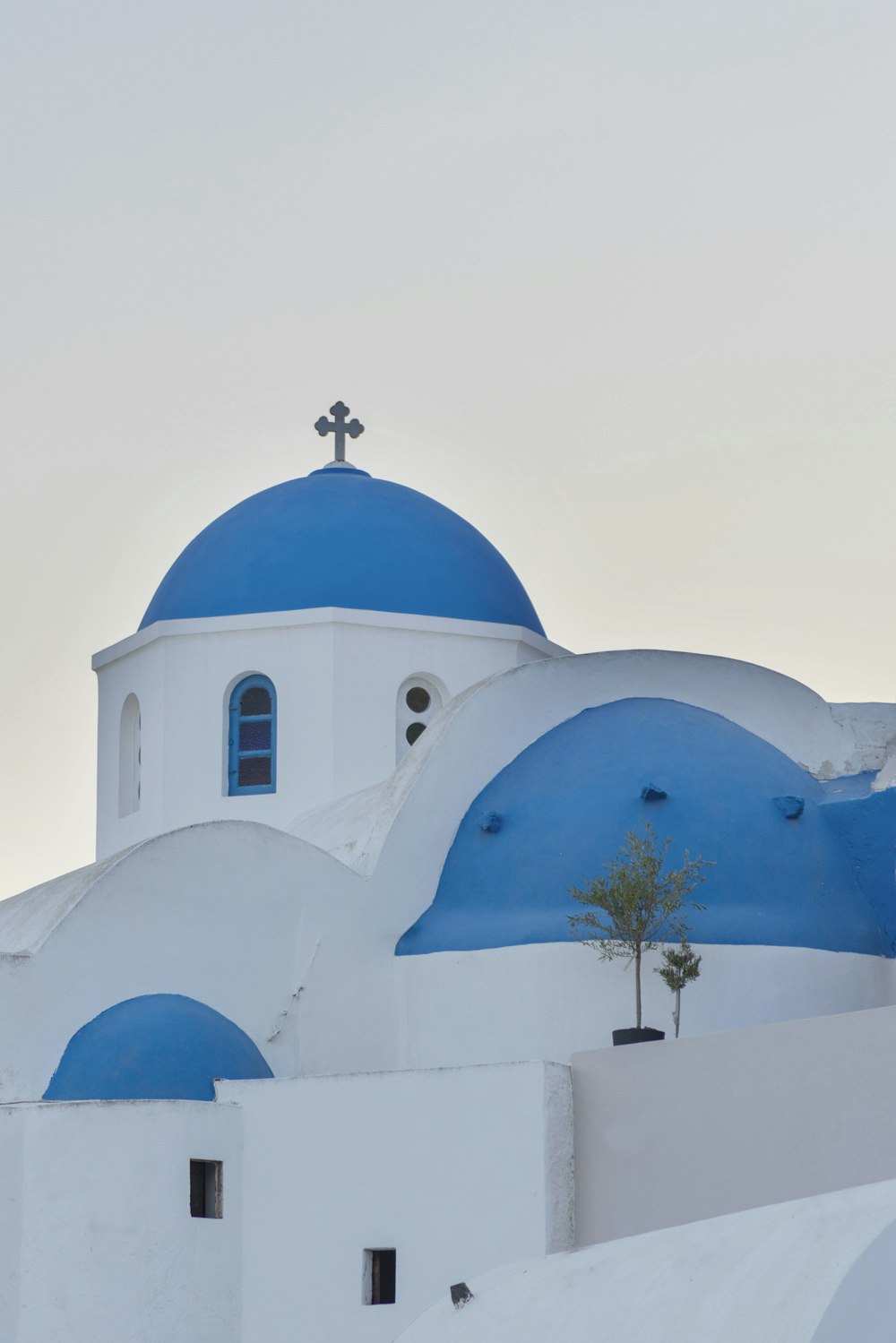 a white and blue building with a cross on top