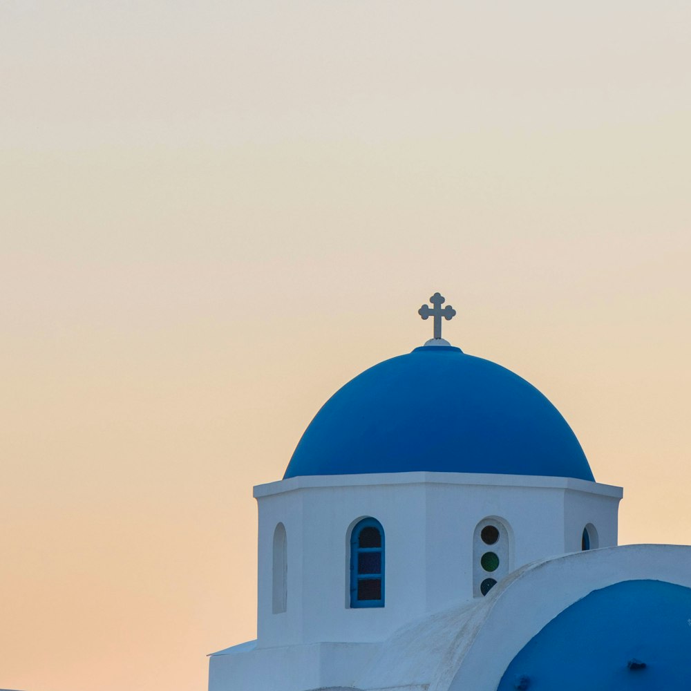 a white and blue building with a cross on top