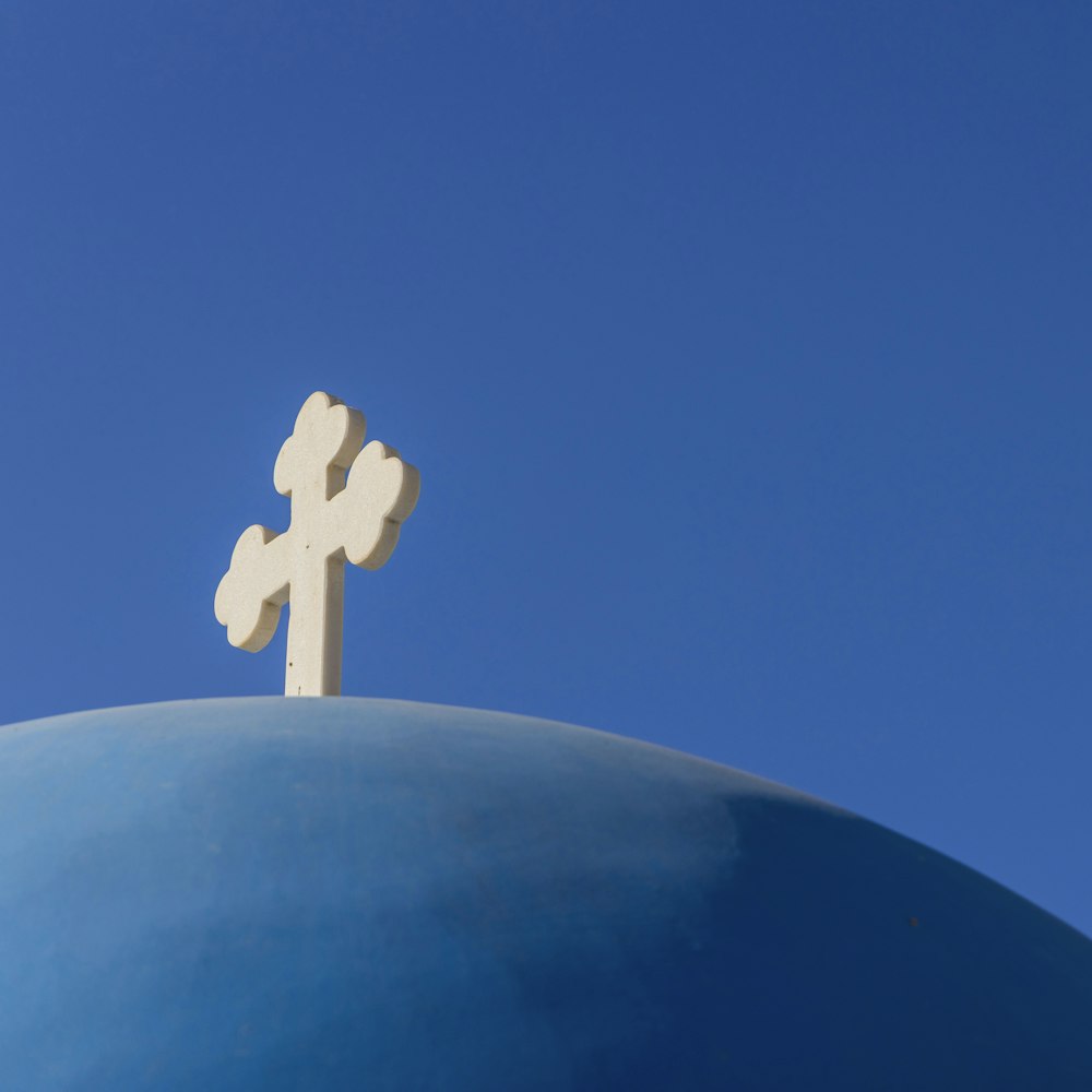 a white cross on top of a blue dome