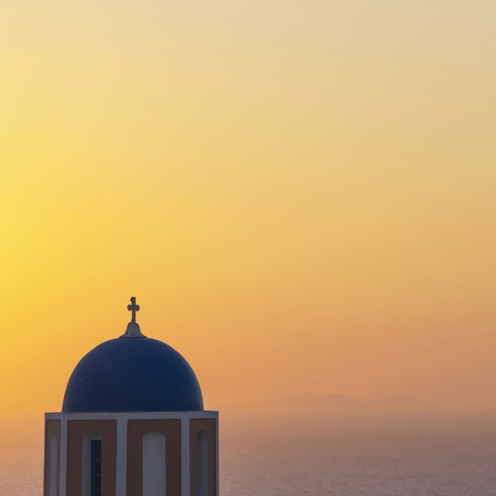 a blue dome with a cross on top of it