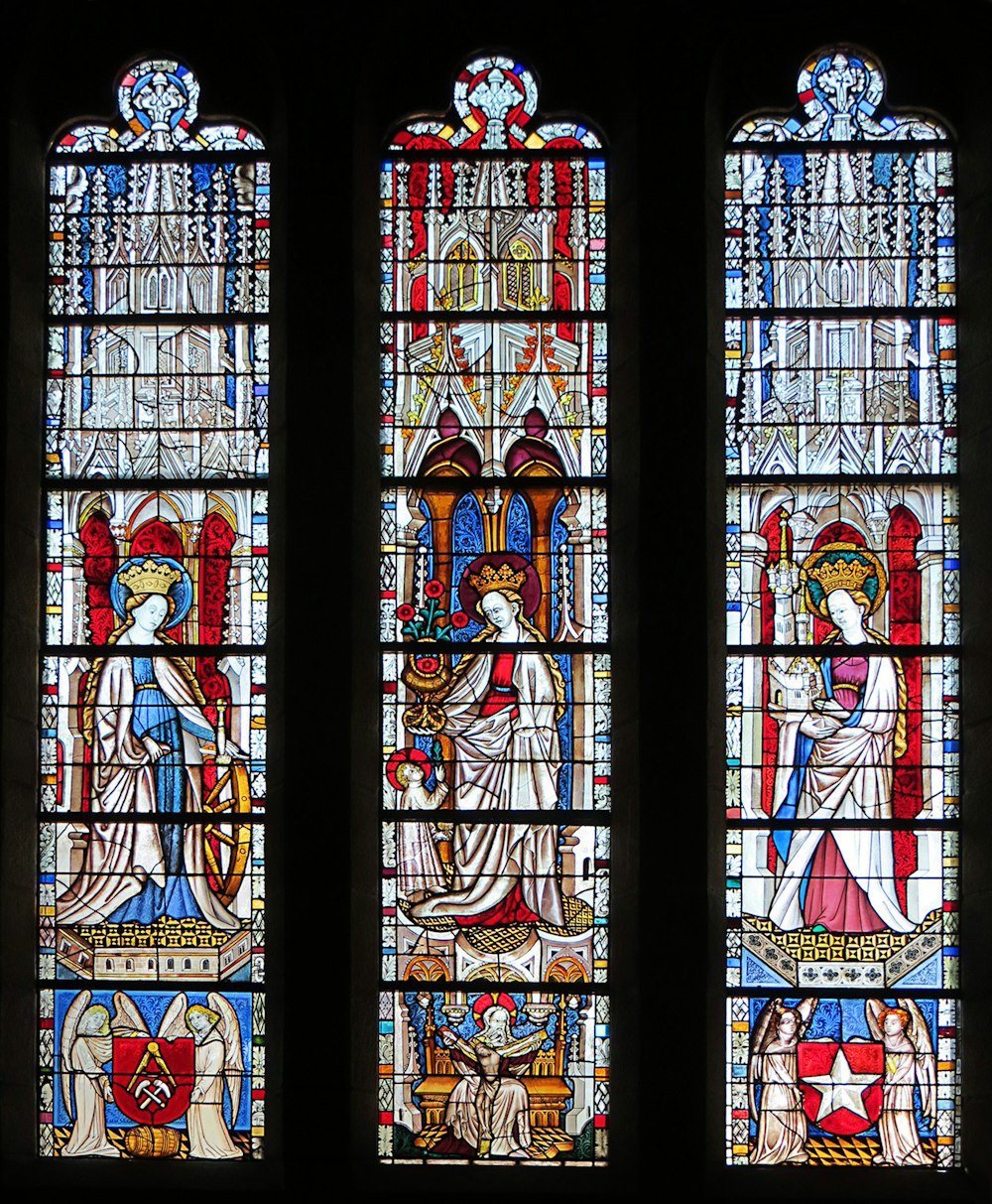 three stained glass windows in a church