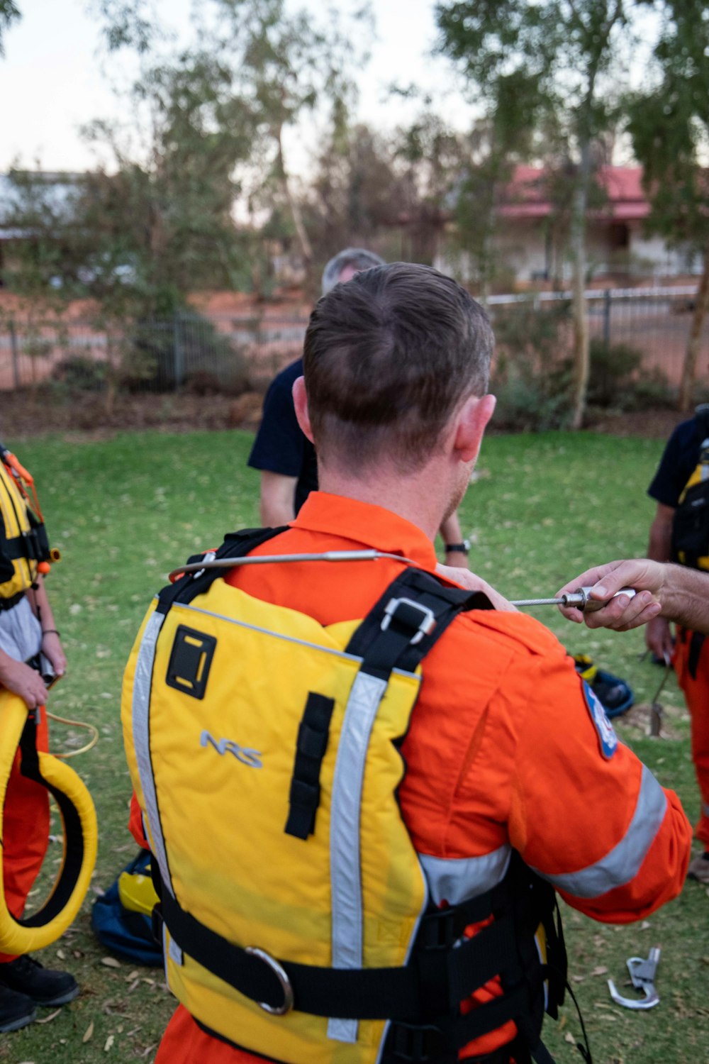 a group of men in orange and yellow uniforms