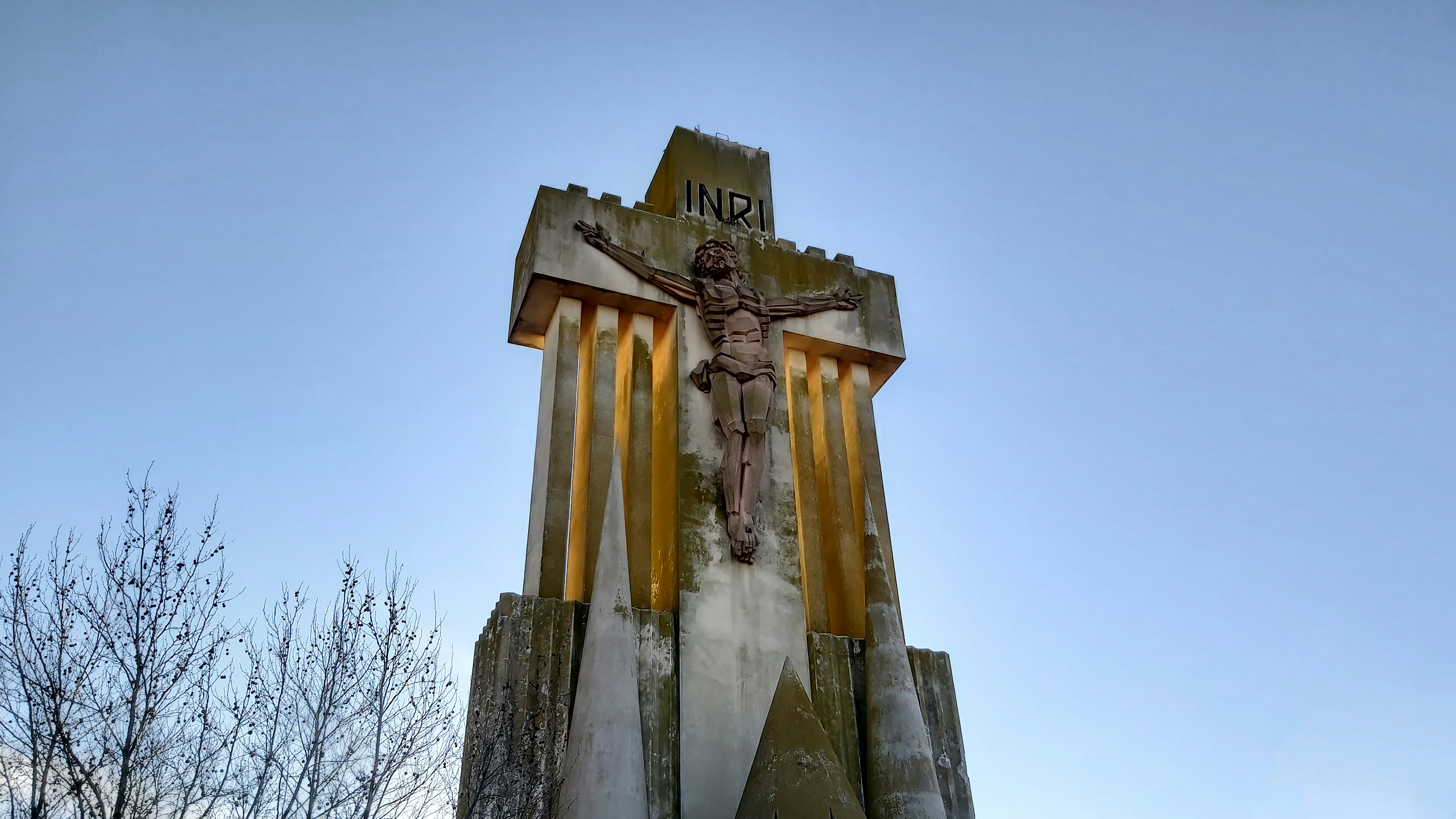 a statue of a crucifix on top of a building