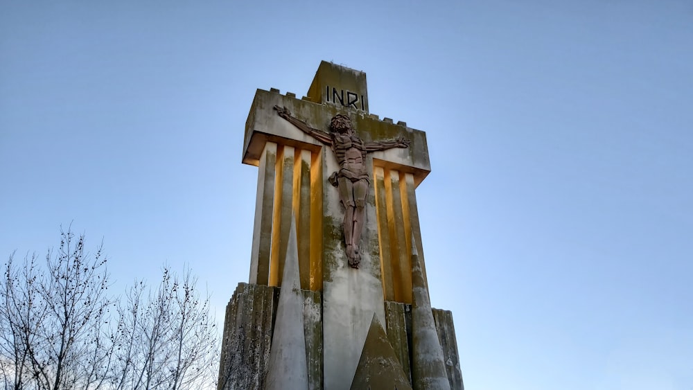 a statue of a crucifix on top of a building