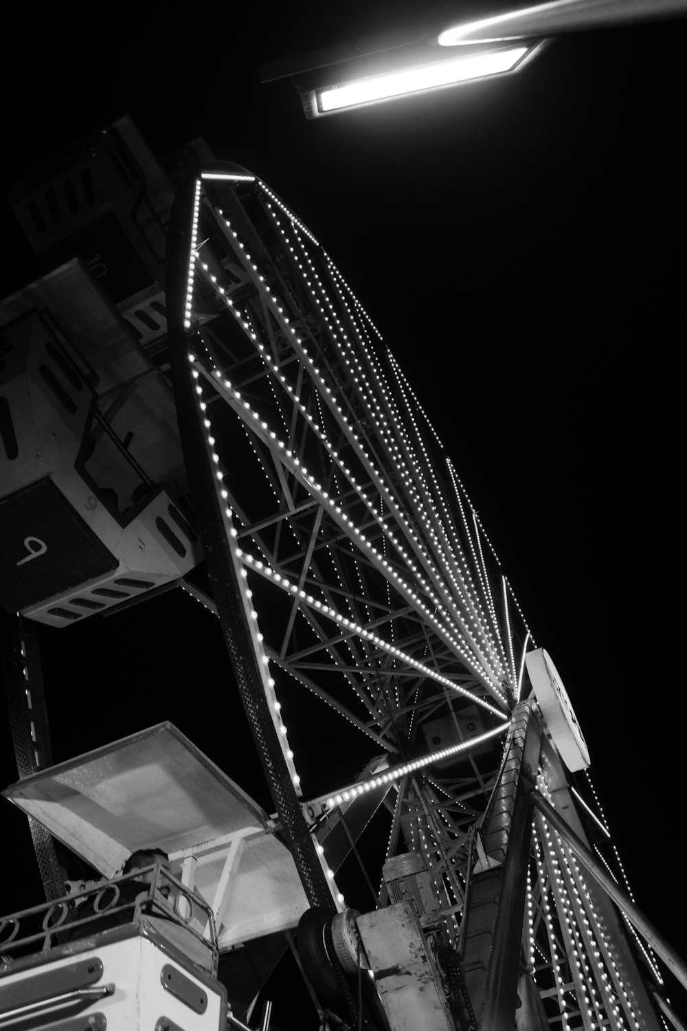 a black and white photo of a ferris wheel