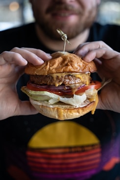 a man holding a hamburger in his hands