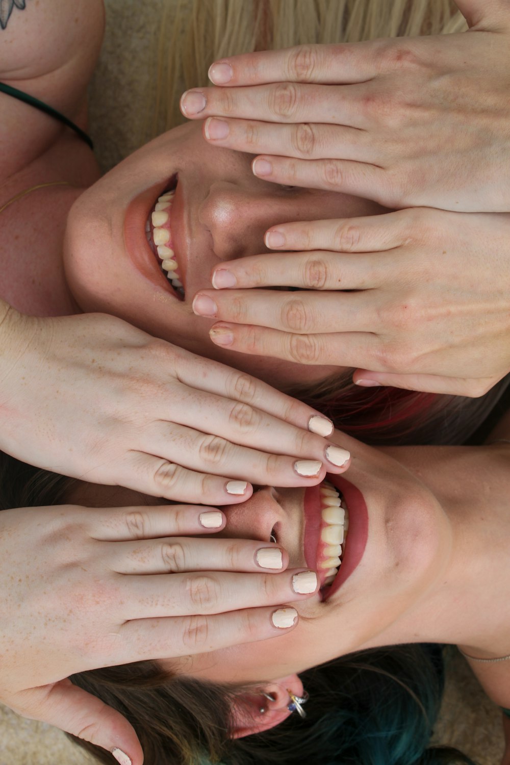 a group of women with their hands on their faces