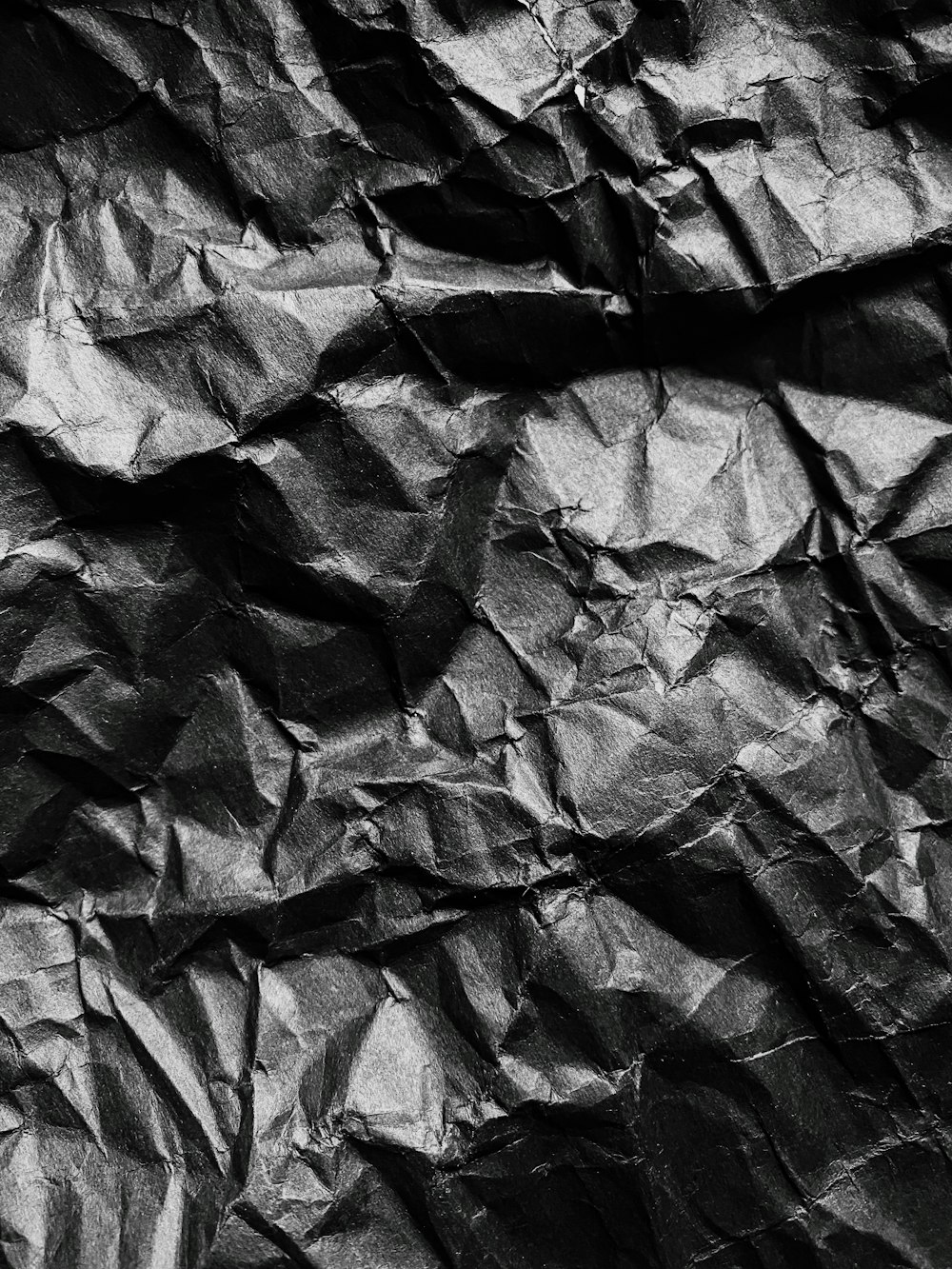 a black and white photo of crumpled paper