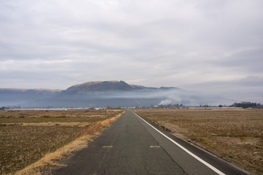 a long road with a mountain in the background