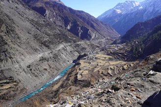 a river running through a valley surrounded by mountains