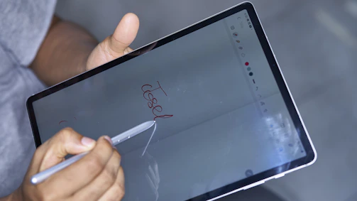 Close-up of a digital signature being applied on a tablet screen.