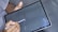 A close-up of hands filling out a loan application form on a tablet.