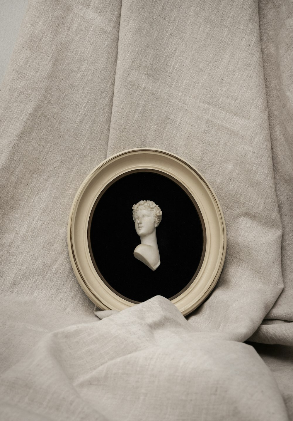 a picture of a bust of a man in a frame