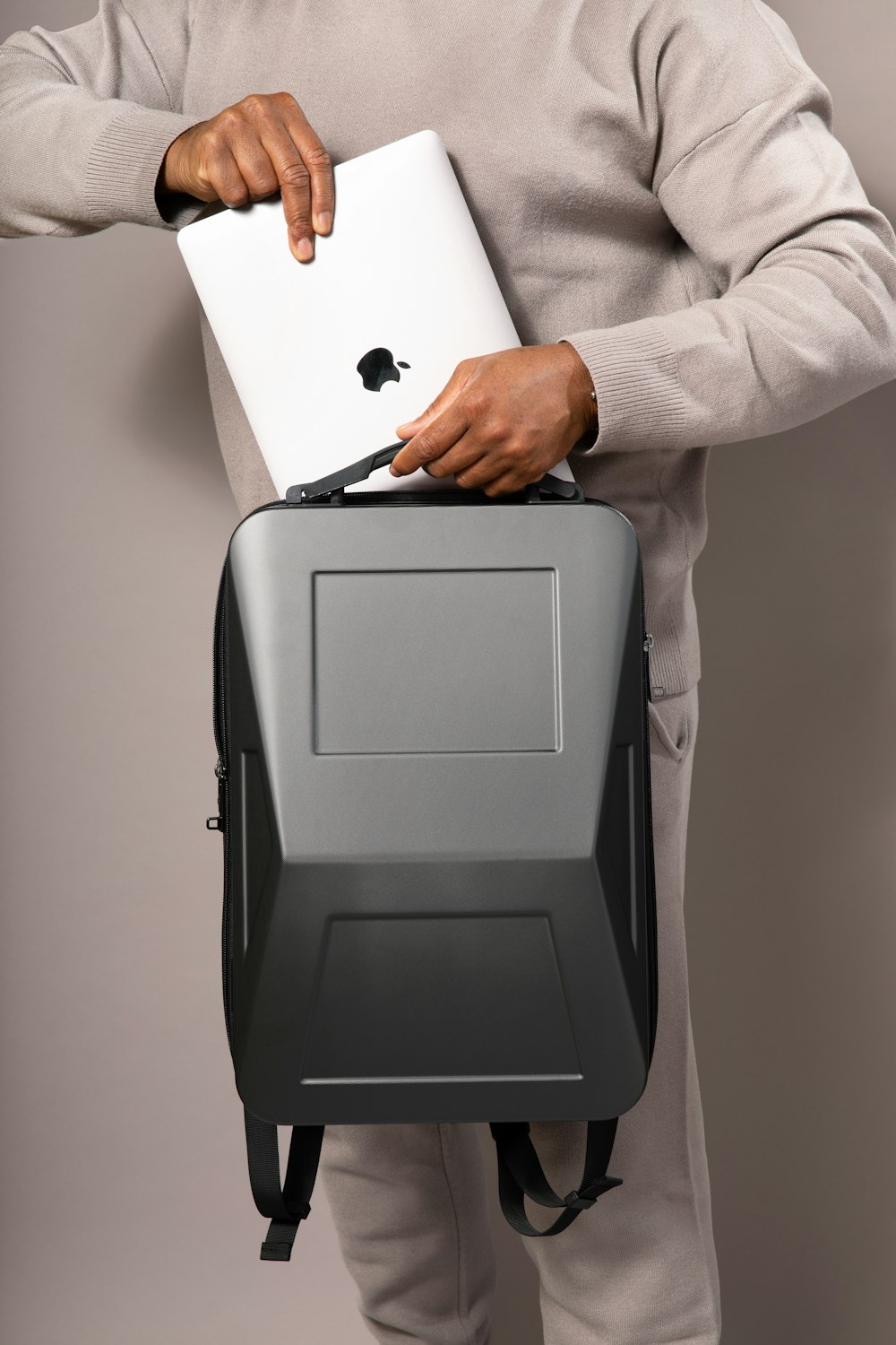 a man holding a laptop in his back pocket