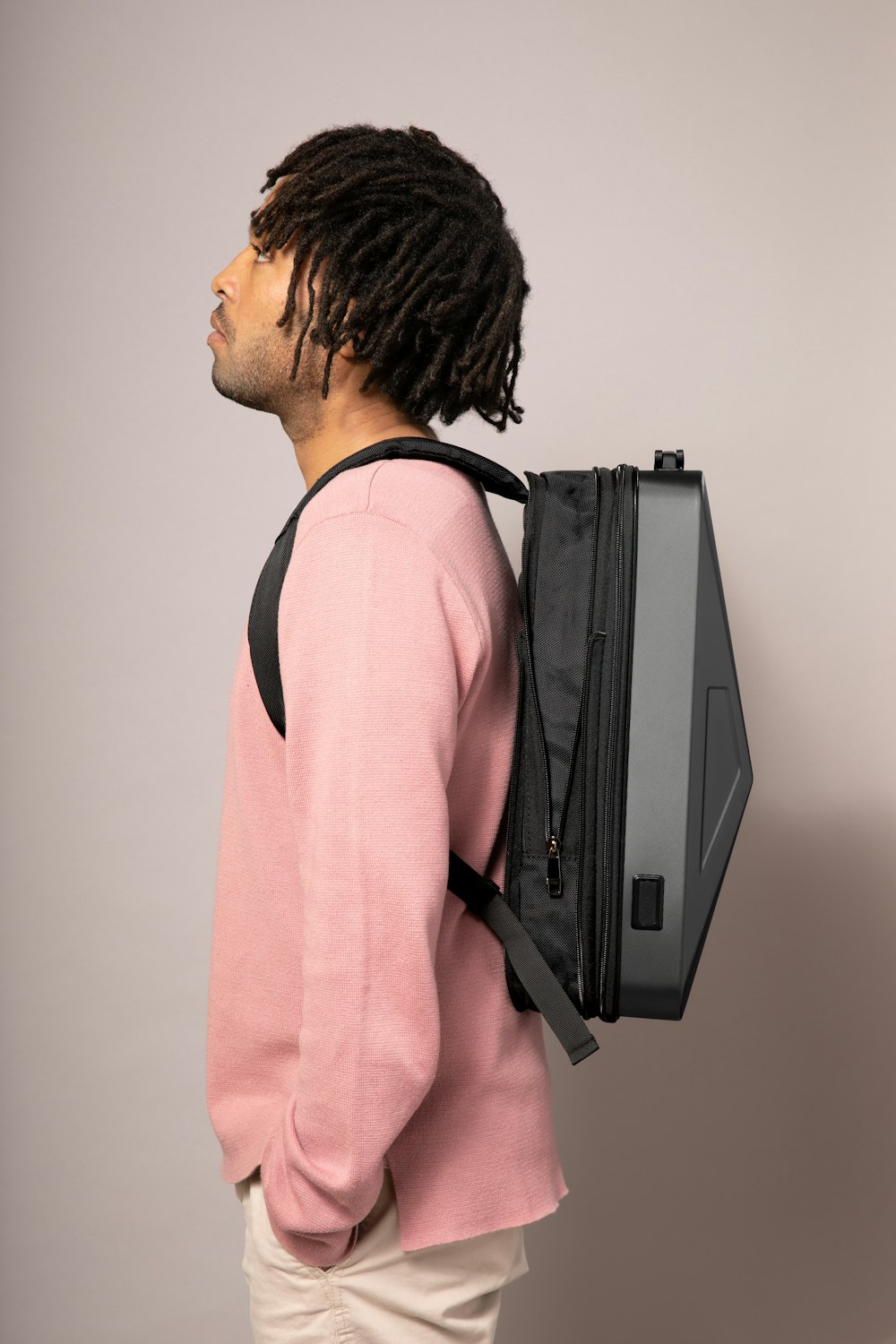 a man with dreadlocks and a backpack