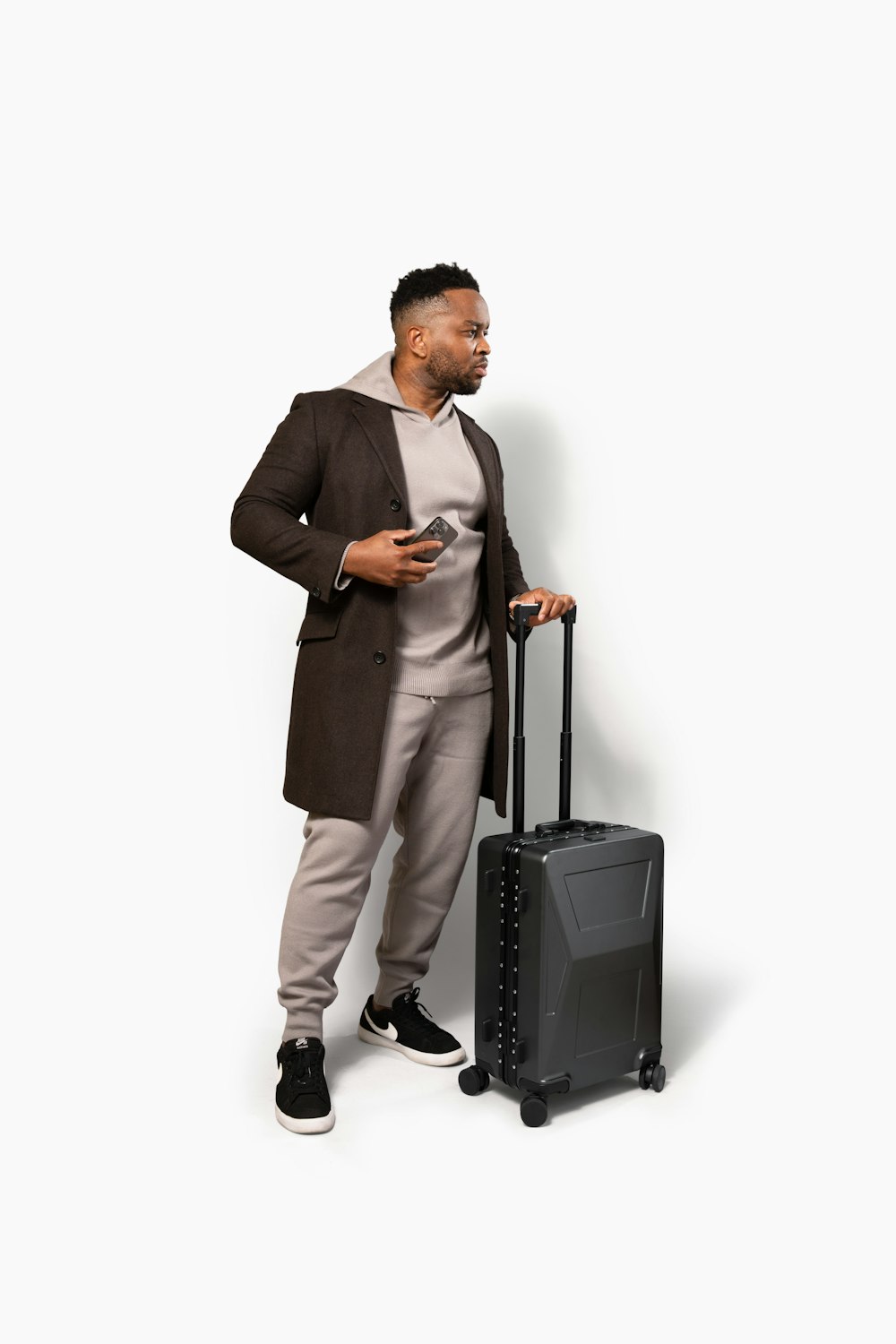 a man standing next to a piece of luggage